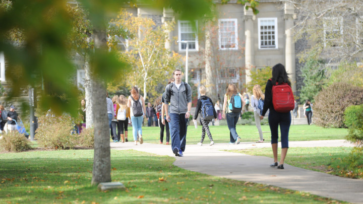Individuals walking on Studley Campus.