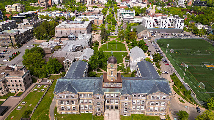 An aerial shot of Dalhousie's Studley Campus where cars can be seen parked on Alumni Crescent, Chemistry and Dunn lots.